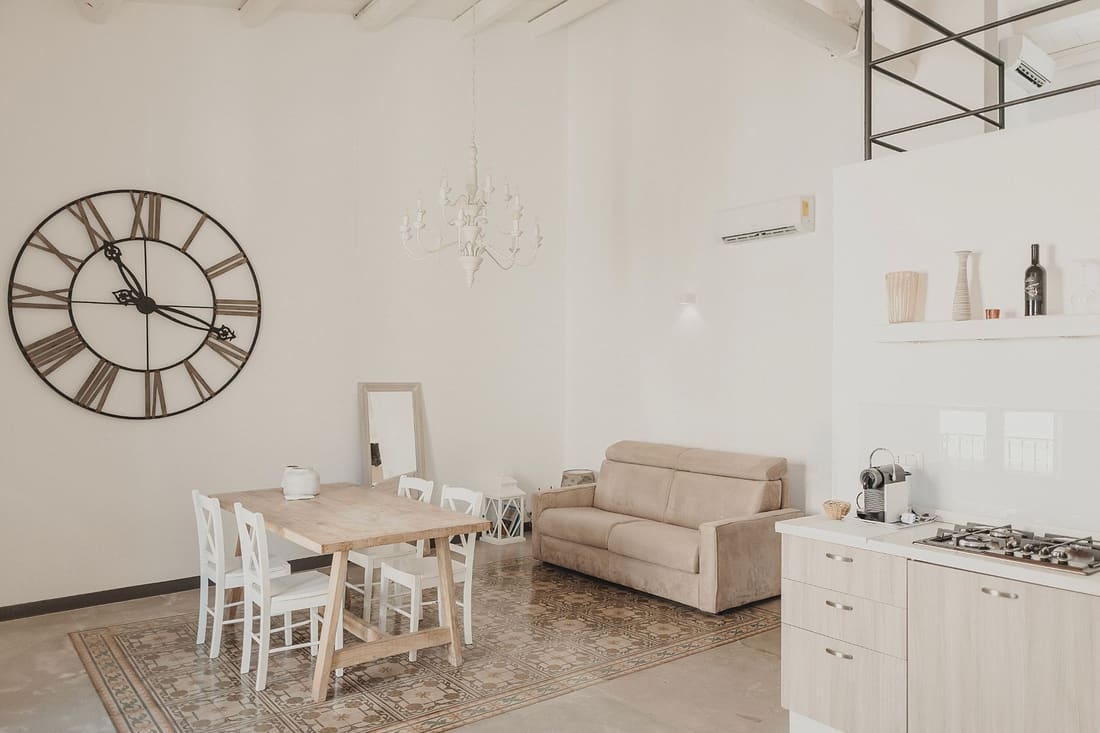 Zona giorno con orologio a parete e tappeto di cementine